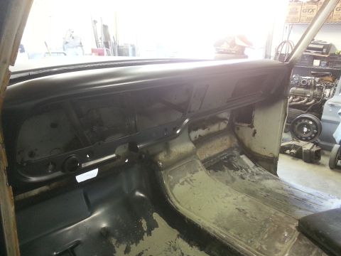1967 Ford F-100 - The interior of a 1967 Ford F-100 shows a bare dashboard and floor, indicating restoration work in progress.