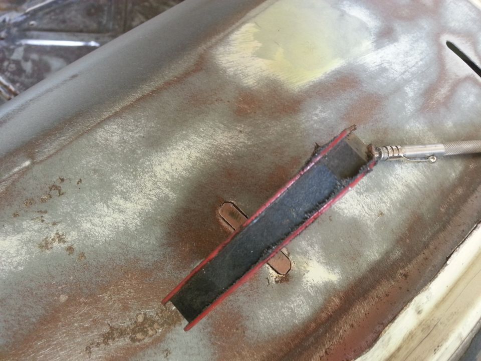 Metal panel with rust and a tool for cleaning