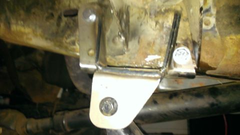 1994 Ford Bronco - A close-up view of a metal bracket attached to the underside of a vehicle's frame.