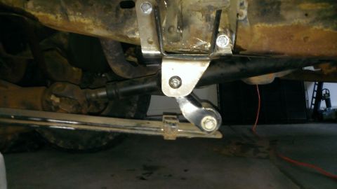 1994 Ford Bronco - Close-up view of the undercarriage of a vehicle, showing suspension components and aftermarket modifications.
