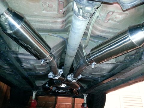 1995 Ford Mustang - Underside view of a vehicle's exhaust system, dual mufflers and an X-pipe configuration.