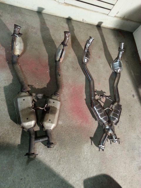 1995 Ford Mustang - Comparison of two exhaust systems, one appears older and one is new stainless steel.