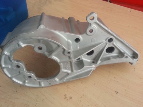 1994 Ford Bronco - This metal bracket is shown from an angle on a wooden surface.