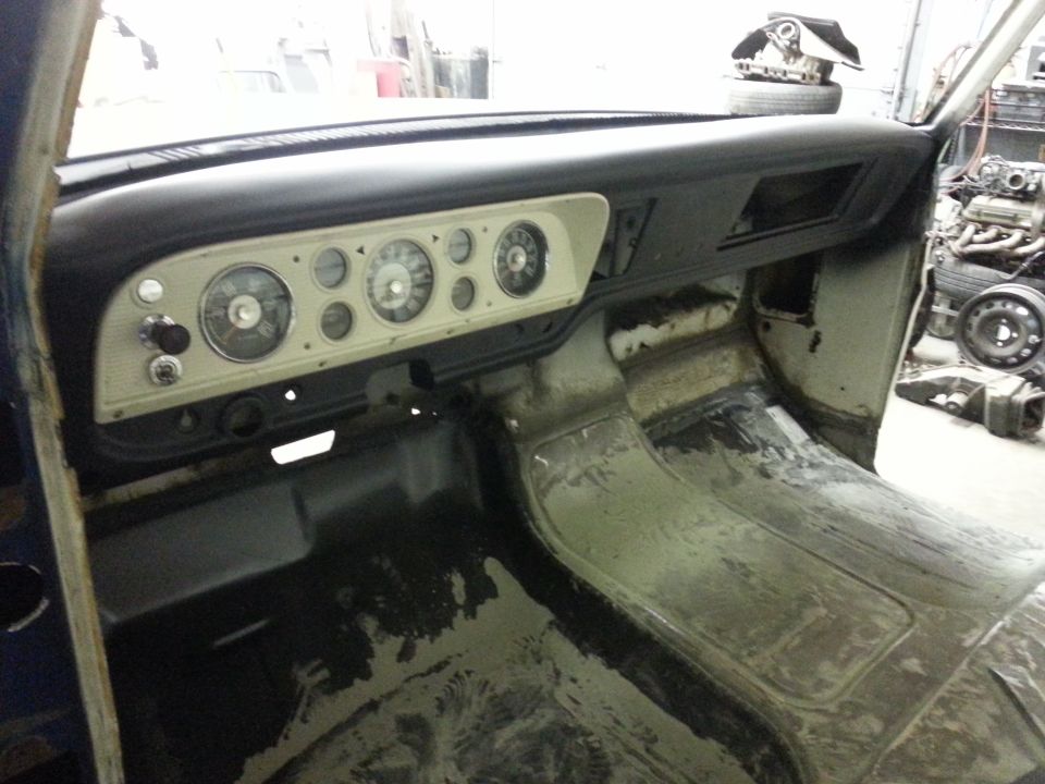 1967 Ford F-100 interior showing dashboard gauges and floor pan