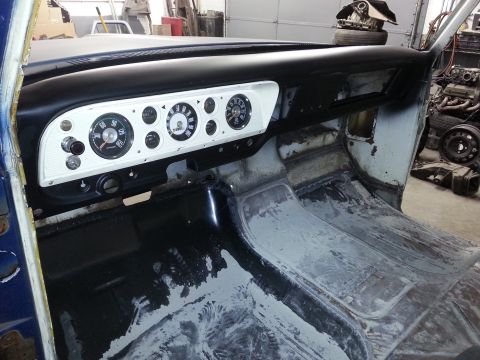 1967 Ford F-100 - The dashboard of a vintage truck, showing its instrument cluster and the bare interior floor.