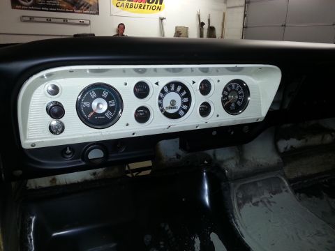 1967 Ford F-100 - The instrument cluster of a 1967 Ford F-100, a speedometer and other gauges.