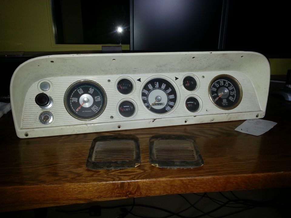 White dashboard instrument cluster with multiple gauges, including a speedometer, fuel, temp, oil, and ammeter