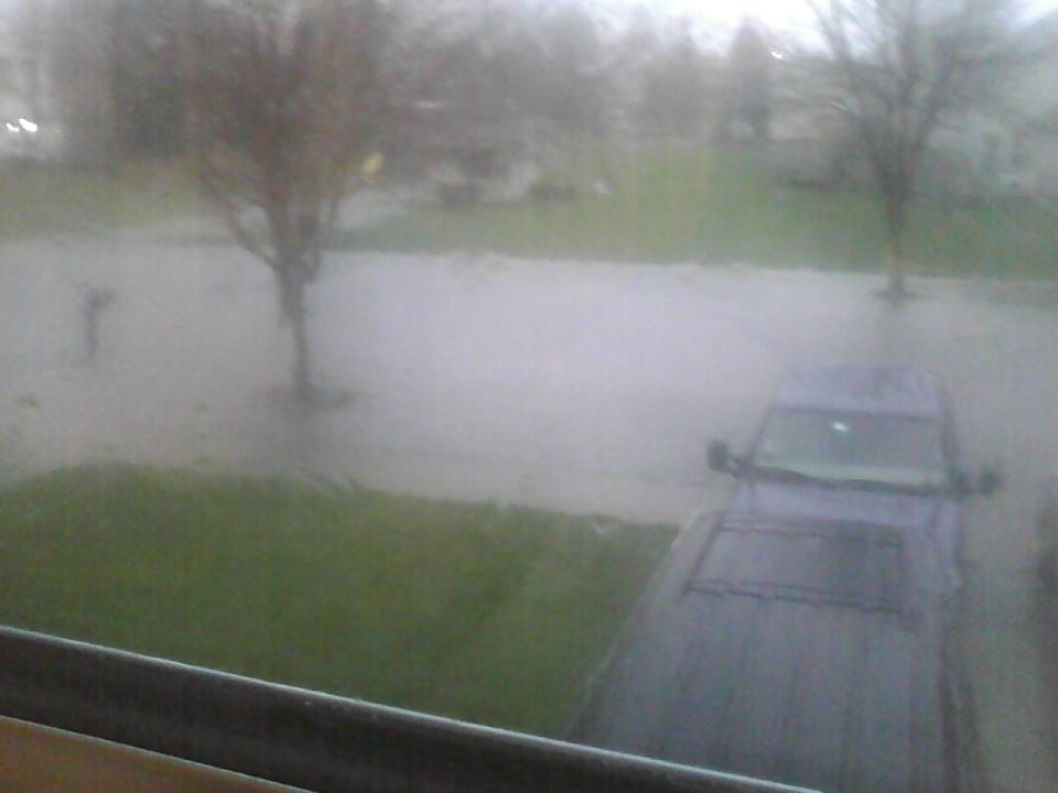 Dark SUV in flooded street