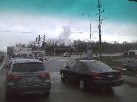 2003 Ford Crown Victoria - View of a traffic intersection during a rainstorm, with several vehicles visible.
