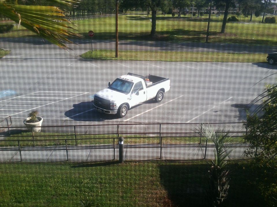 White Ford F-250 Super Duty pickup truck, 2005 model year, parked in a lot