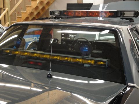 1991 Ford LTD Crown Victoria - Interior view of a 1991 Ford Crown Victoria LTD police car, showing the dashboard and light bar.
