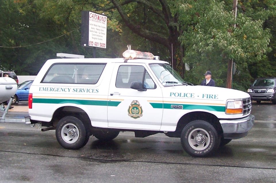 White 1994 Ford Bronco with "EMERGENCY SERVICES" and "POLICE - FIRE" markings, parked on asphalt