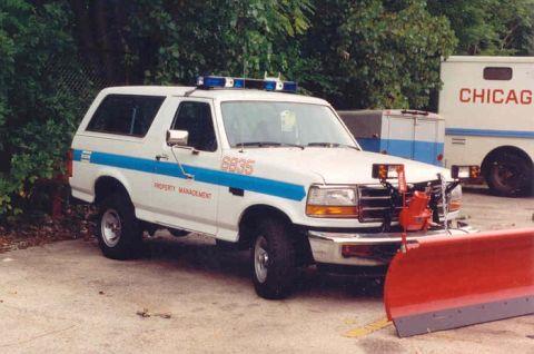 1994 Ford Bronco - This 1994 Ford Bronco is equipped with a snow plow and emergency lights, seen near a Chicago vehicle.