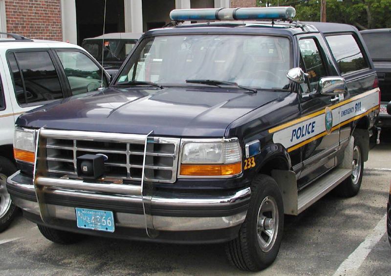 1994 Ford Bronco police SUV with light bar and 'POLICE' markings
