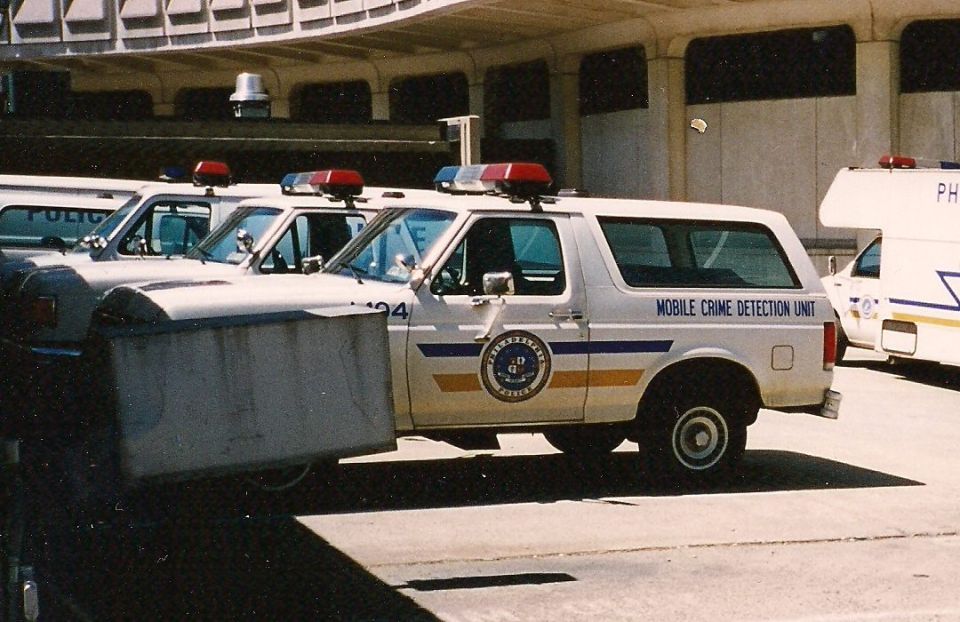 White Ford Bronco police vehicle with "MOBILE CRIME DETECTION UNIT" text, side view