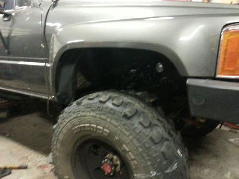 1987 Toyota 4Runner - Close-up of the front fender and large tire on a 1987 Toyota 4Runner.