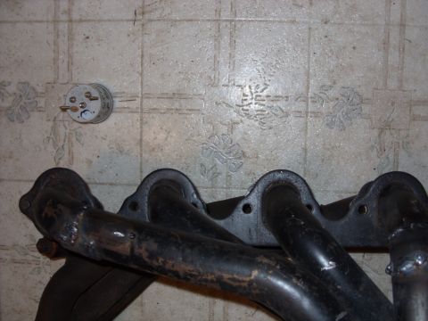 1967 Ford F-250 - Exhaust manifold part shown on a tiled floor.