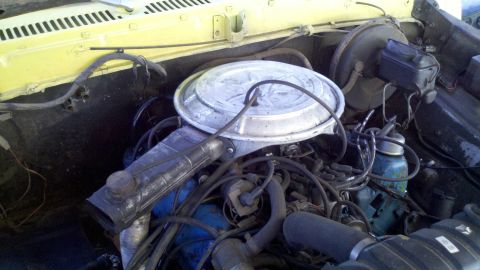 1978 Ford Bronco - Close-up view of a vehicle's engine compartment, showing the air intake and associated components.