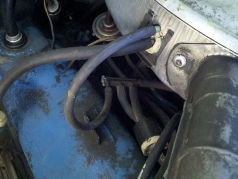1978 Ford Bronco - Close-up view of engine bay components, including hoses and metal parts, with visible dirt and wear.