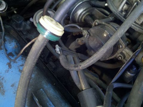 1978 Ford Bronco - Close-up view of engine components including carburetor and distributor with hoses.