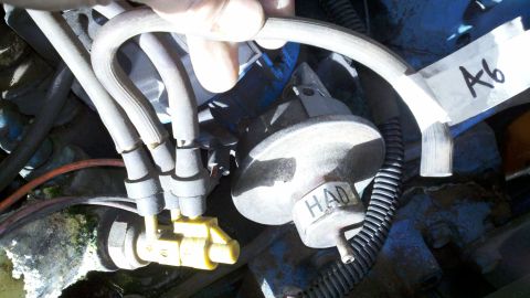 1978 Ford Bronco - Close-up of an engine part with hoses and handwritten labels 'HAD' and 'A6'.