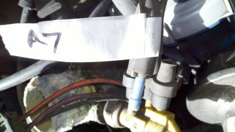 1978 Ford Bronco - A label marked "A7" is attached to a hose near some engine parts.