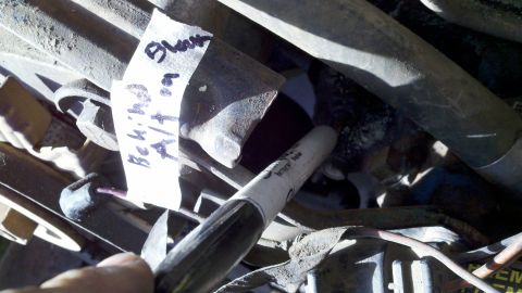 1978 Ford Bronco - Close-up of engine components, including a handwritten label that may indicate a part failure or year.