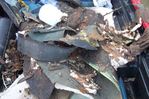 1980 Ford Bronco - A pile of torn-out interior material, rotted carpet, crumbling jute padding and disintegrating foam-backed insulation, heaped in a black pl…