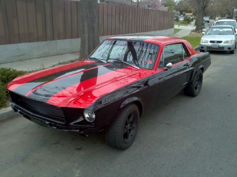 1987 Ford Bronco - This black 1967 Ford Mustang coupe features red racing stripes and black wheels.