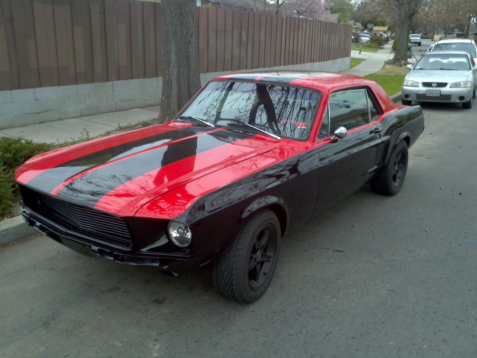 1967 Ford Mustang coupe, black with red racing stripes on hood and roof, black wheels