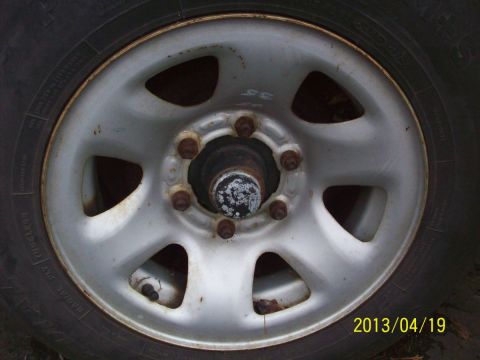 1969 Ford Torino - A close-up view of a vehicle's wheel and tire, showing the lug nuts and rim detail.