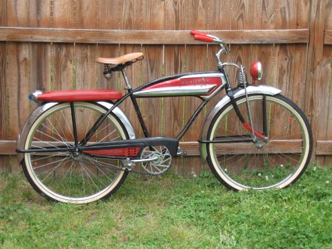 1994 Ford Bronco - Side view of a vintage J.C. Higgins bicycle parked on grass in front of a wooden fence.