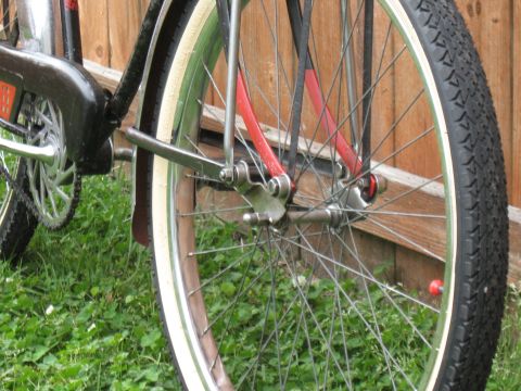 1994 Ford Bronco - Detail shot of a bicycle's front wheel, showing the spokes, tire, and part of the red frame.
