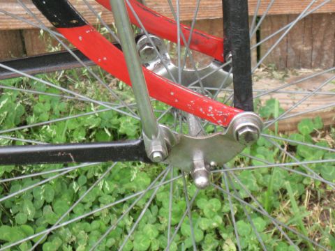 1994 Ford Bronco - Detail of a bicycle's rear wheel assembly, showing the spokes and frame components against a backdrop of clover.