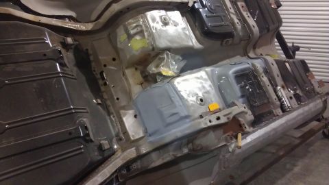 1972 Pontiac Trans Am - The underside of a vehicle is shown, with various metal components and repairs visible.
