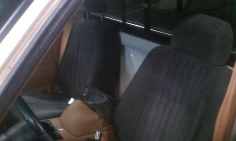 1991 Chevrolet S10 - The interior of a 1991 Chevrolet S10 pickup truck is visible, dark fabric seats and a tan center console.
