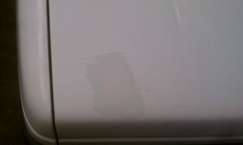 1991 Chevrolet S10 - A close-up view of a white vehicle panel shows a prominent scuff mark.