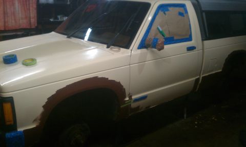1991 Chevrolet S10 - This 1991 Chevrolet S10 pickup truck is undergoing preparation for a paint job, with masking tape applied to the driver's side door and fen…