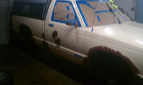 1991 Chevrolet S10 - Pickup truck side view, prepped for paint with masking tape and showing rust patches.