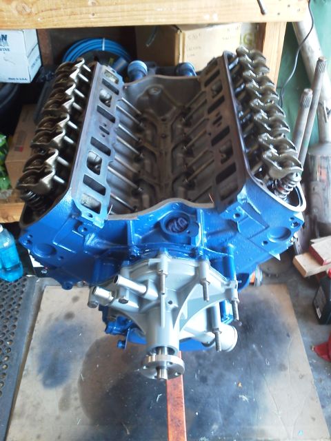 1988 Ford Bronco - A freshly painted V8 engine sits on an engine stand, ready for installation.