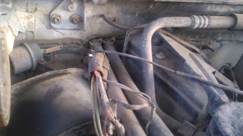 1995 Ford Bronco - This image shows various hoses and electrical wiring within the engine compartment of a vehicle.