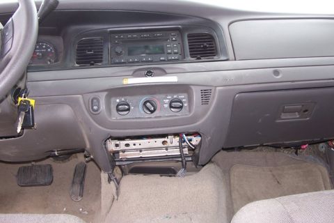 2007 Ford Crown Victoria - The interior dashboard of a 2007 Ford Crown Victoria features its original radio and climate controls, with the steering wheel visible on t…