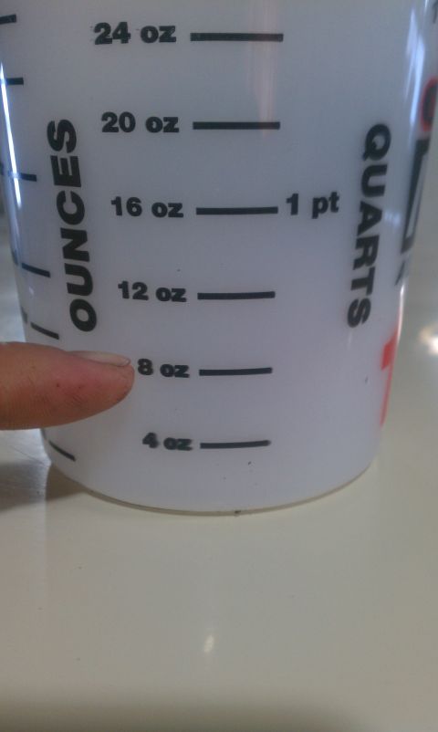 1991 Chevrolet S10 - A close-up shows a finger indicating the 8 oz measurement on a liquid measuring cup.