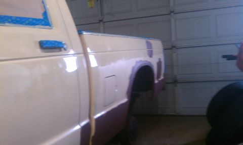 1991 Chevrolet S10 - A white pickup truck is undergoing bodywork in a garage, with its windows taped off for painting.