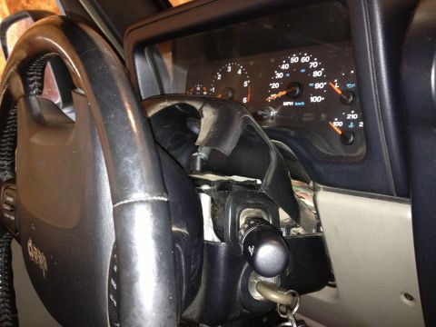 2005 Jeep Wrangler - Close-up view of the dashboard and steering wheel of a Jeep, showing the instrument cluster and turn signal stalk.