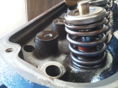 1988 Ford Bronco - Detail of an engine valve spring assembly, showing the spring, retainer, and valve stem.