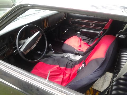 1975 Chevrolet Chevelle - Interior view of a 1975 Chevrolet Chevelle, custom red and black seat covers.