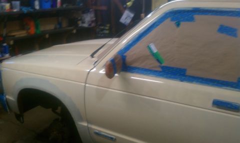 1991 Chevrolet S10 - Side view of a 1991 Chevrolet S10 with masking tape applied to the door and fender.