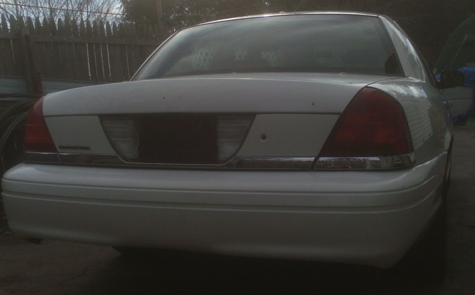 2006 Ford Crown Victoria rear bumper and taillights, chrome trim strip above bumper