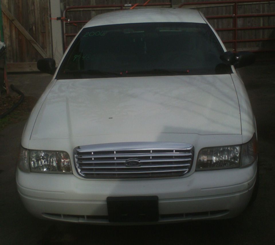 White 2006 Ford Crown Victoria front view, chrome grille, headlights visible